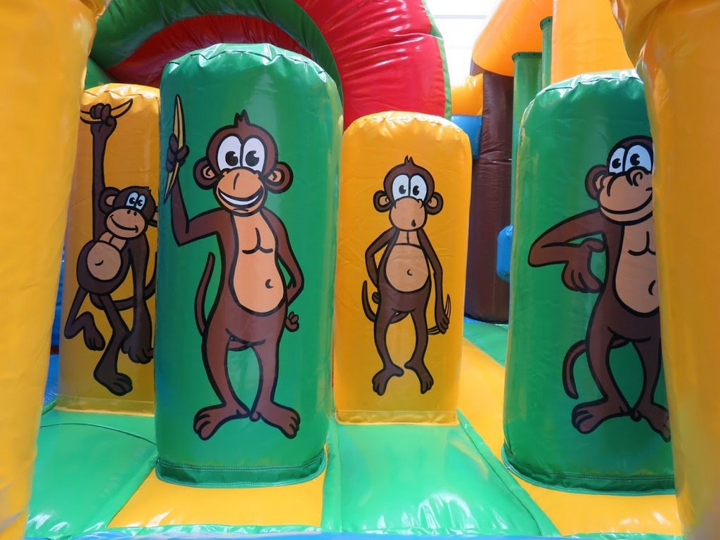 Structure gonflable combo singe avec obstacles de jeux cylindriques.